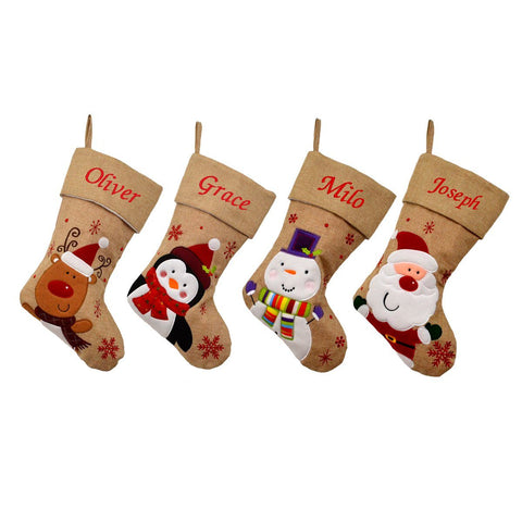 4 personalised hessian Christmas stockings, one with a penguin, one with Santa, one with a snowman and one with a reindeer. All the stockings have a christian name embroidered on the top of the stocking in red lettering. 