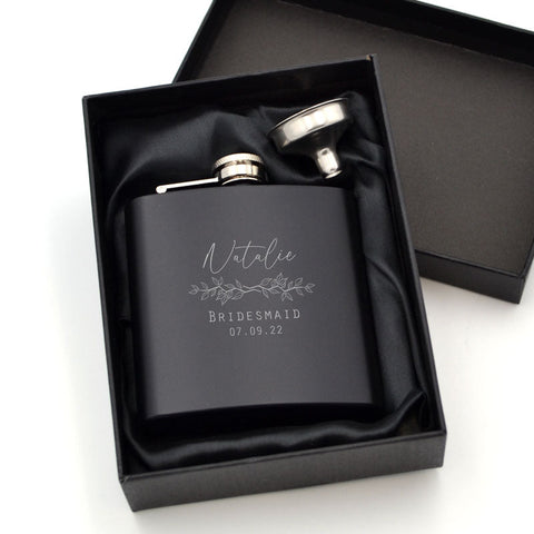 A personalised bridesmaid hip flask in matt back with a custom engraving on the font.